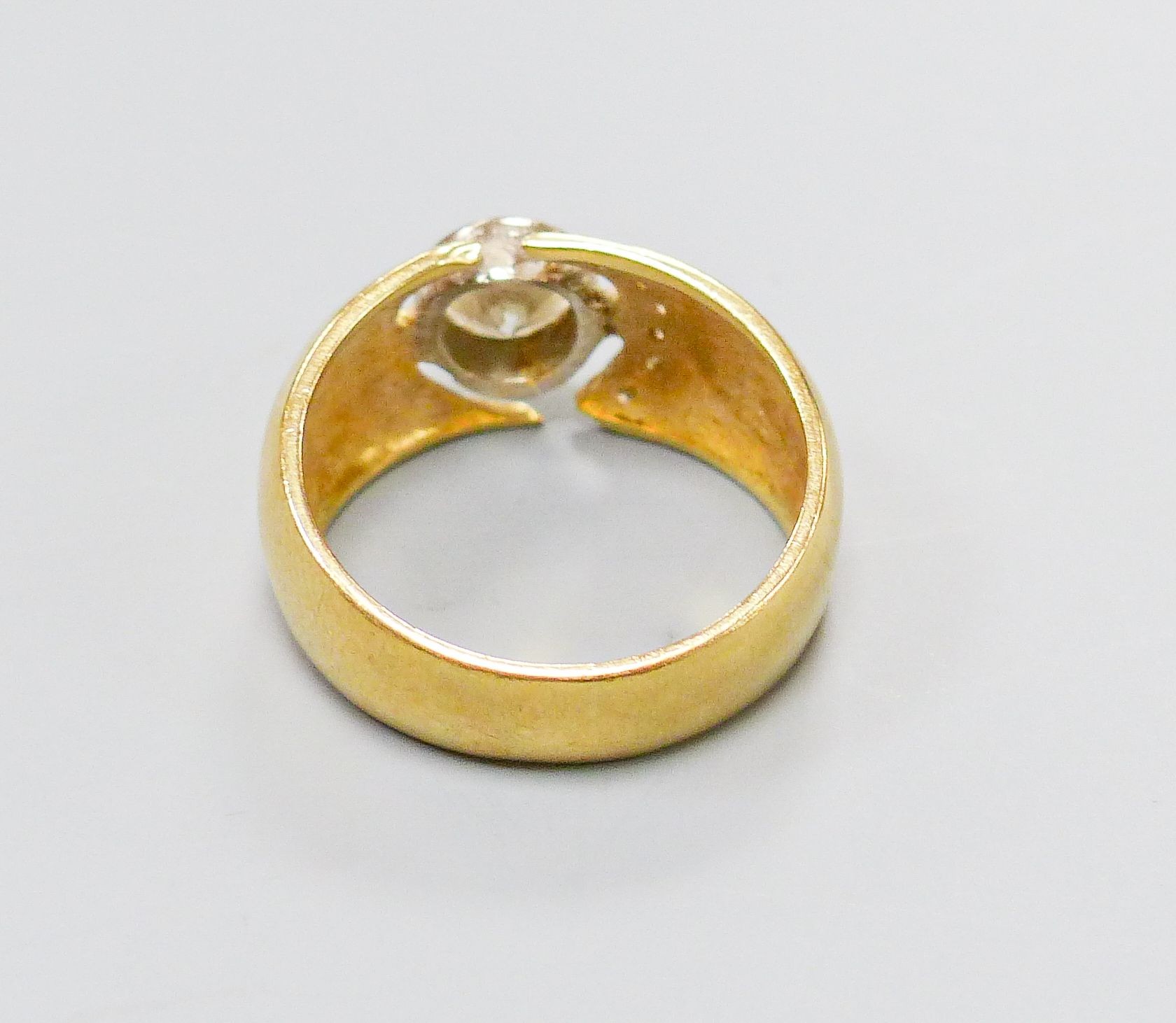 A modern 750 yellow metal and single stone diamond ring, with diamond set open work setting, size M, gross 6.4 grams.